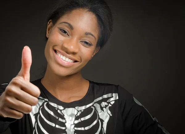 Model gesturing thumb up sign — Stock Photo, Image