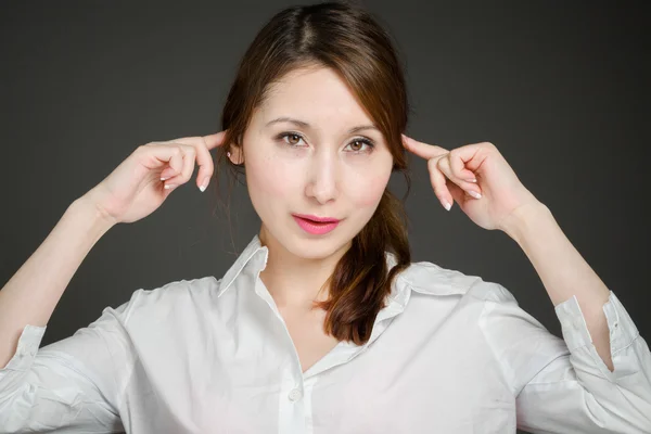 Model plugging ears by fingers — Stock Photo, Image