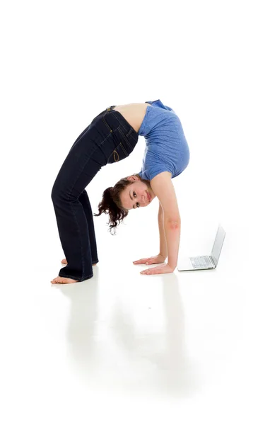 Gymnastic Model stretching with laptop — Stock Photo, Image