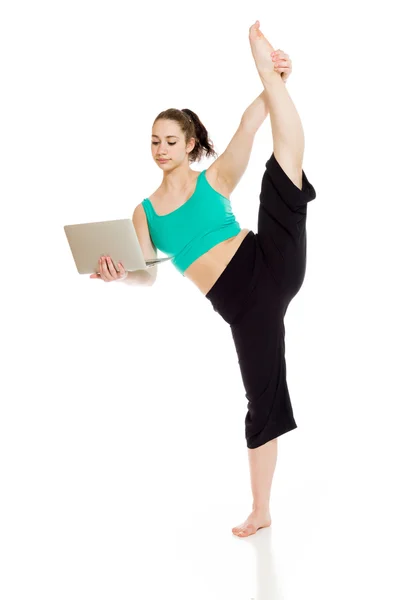 Gymnastic Model stretching with laptop — Stock Photo, Image