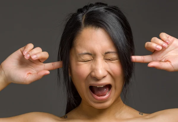 Model plugging ears by fingers — Stock Photo, Image