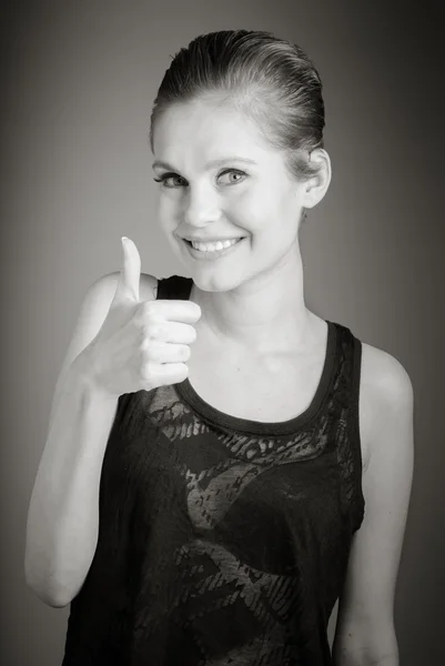 Woman gesturing thumb up sign — Stock Photo, Image