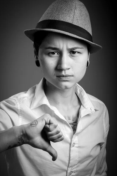 Woman gesturing thumb down sign — Stock Photo, Image