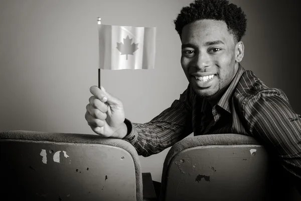 Man holding Canadian flag in hand — Stock Photo, Image