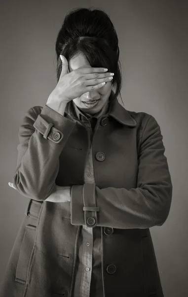 Model ashamed hiding face in hand — Stock Photo, Image