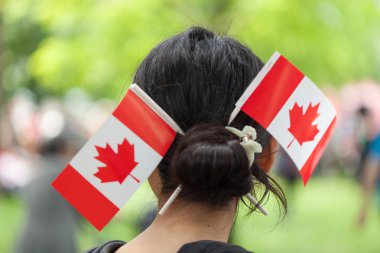 Woman with Canadian flags in her hair bun clipart