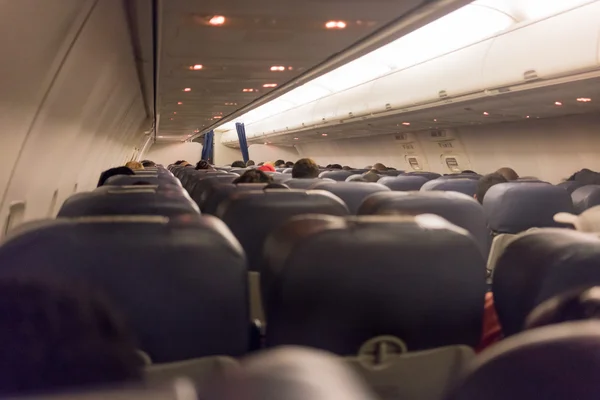 Airplane aisle with group of passengers — Stock Photo, Image