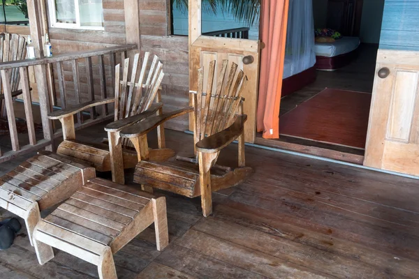 Adirondack chairs at porch of tourist resort — Stock Photo, Image