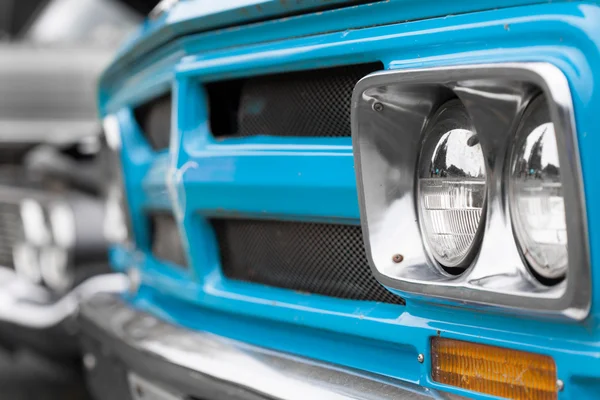 Right headlights of a blue vintage car — Stock Photo, Image