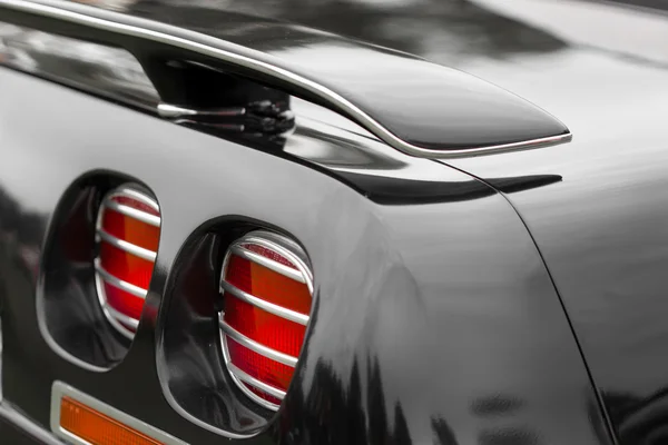 Red tail lights of a black vintage car — Stock Photo, Image