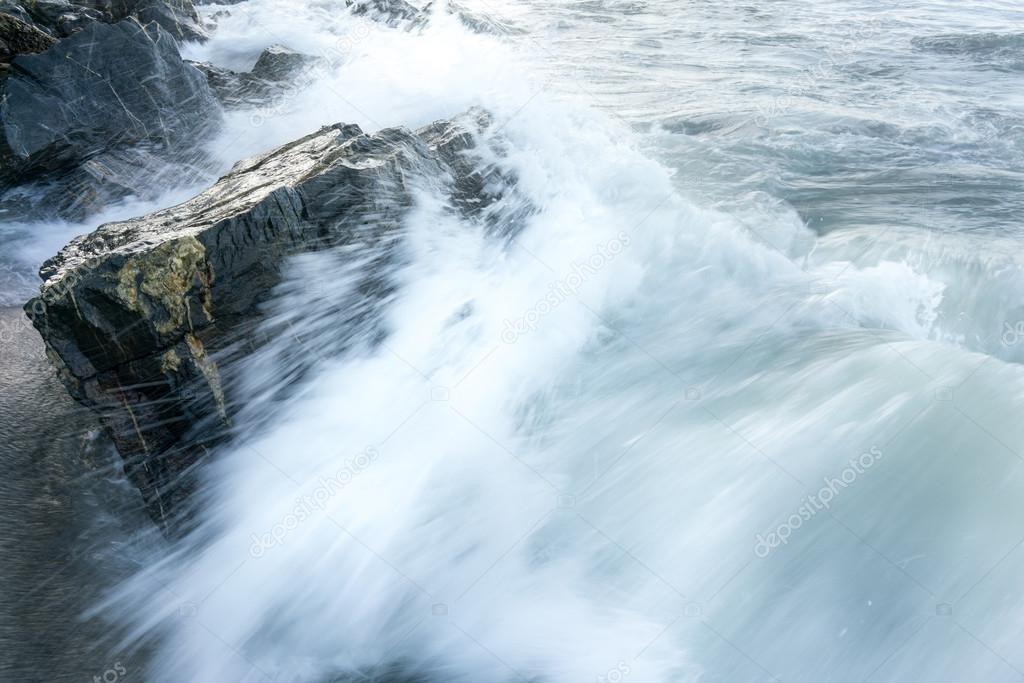 Waves breaking against rocks on the coast