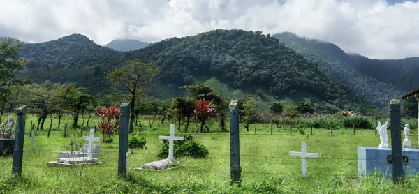 Cimetière sur terrain avec montagnes en arrière-plan — Photo