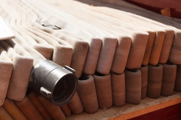 Rolled up fire hoses at fire station — Stock Photo, Image