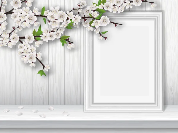 Весной цветущая вишневая ветвь и фоторамка на белом столе — стоковый вектор