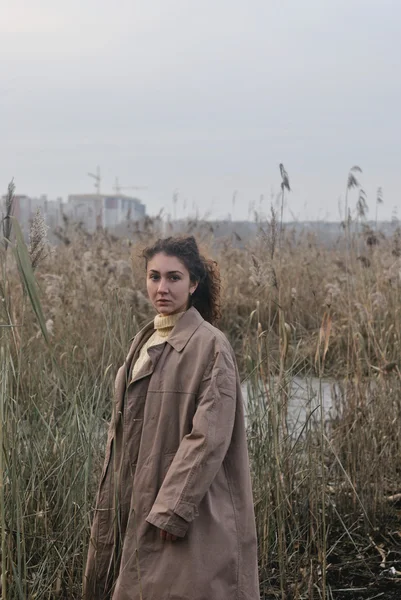Retrato foto de menina vestindo casaco de pé na natureza fundo da cidade — Fotografia de Stock