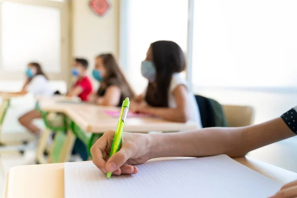 Group of students with face mask back at school after covid-19 quarantine and lockdown.