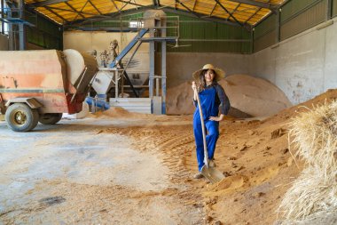 Farmer in a barn with a pitchfork full of hay