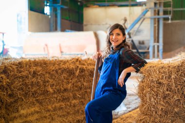 close-up of female farmer resting in the barn