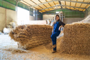 female farmer resting for a while in the barn