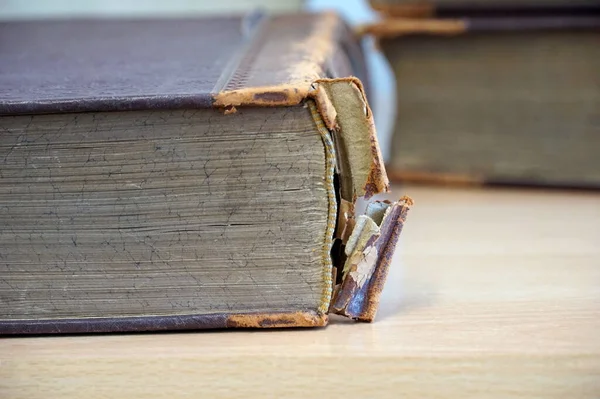 The torn back of an old and dusty book prepared for reparation