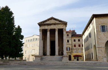 Touristic attraction the temple of roman emperor Augustus from the time of the Roman Empire on the main square in the Croatian town of Pula clipart