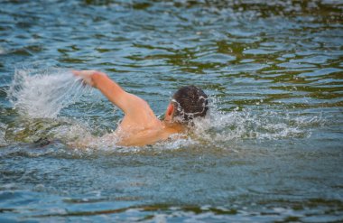 Adam bir dağ nehrinde sürünüyor.