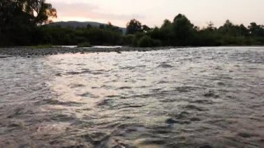 Summer landscape of a mountain river at sunset hour