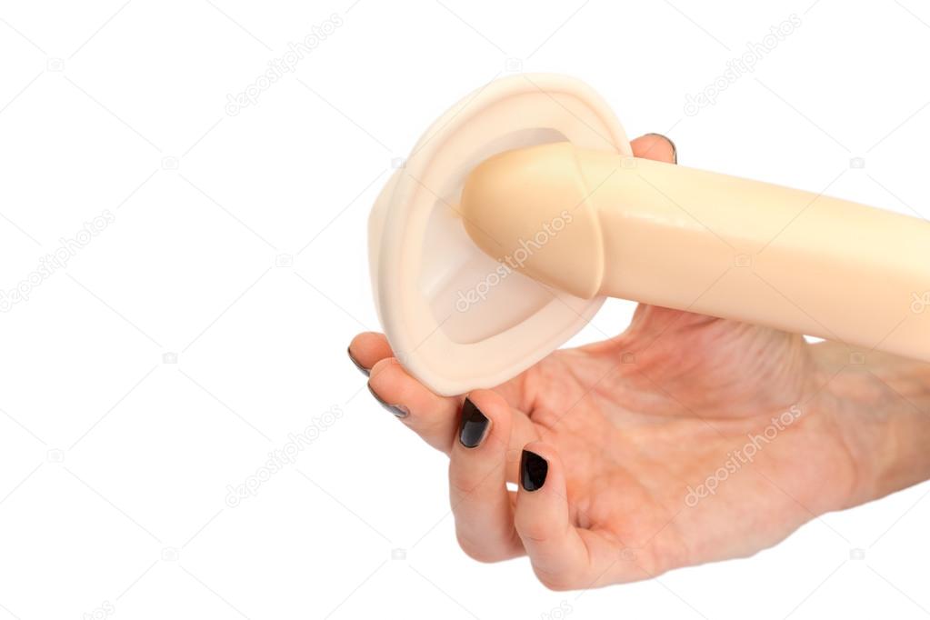 Hand of woman holding model of human penis and pessary