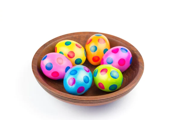 Several colorful painted Easter chicken eggs on wooden scale — Stock Photo, Image