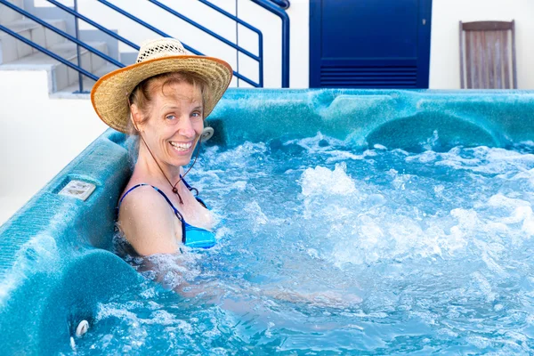 Middle aged woman bathing in hot tub — Stock Photo, Image