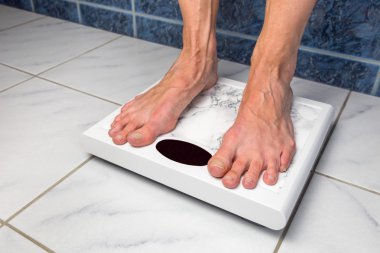 Female feet on bathroom scales clipart