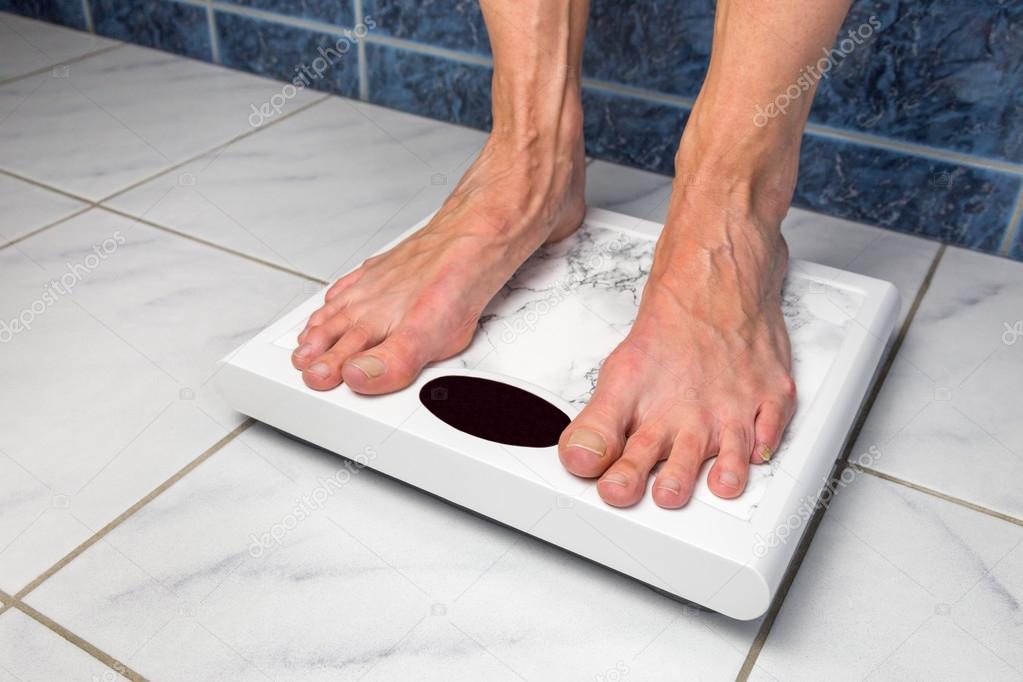 Female feet on bathroom scales — Stock Photo © benschonewille 76014965
