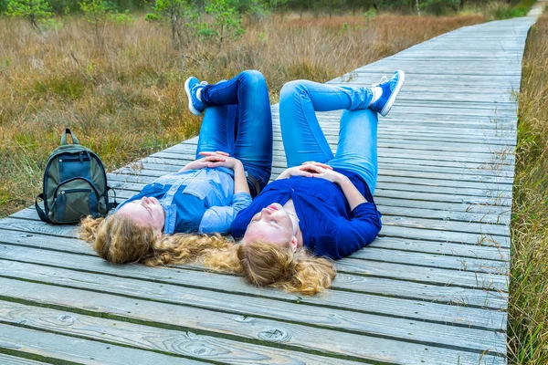 Dvě dívky, které leží na zádech v přírodě — Stock fotografie