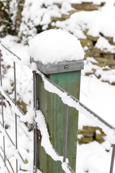 Snow on wooden pole and fence — Stock Photo, Image