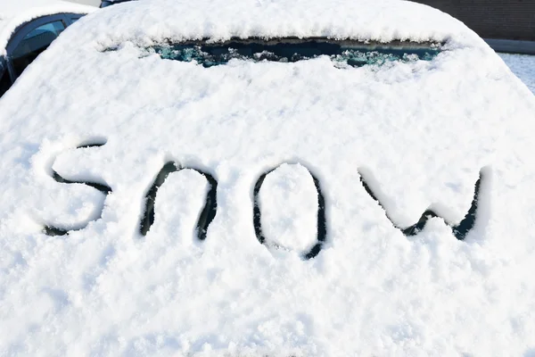 Word snow on windshield of car — Stock Photo, Image