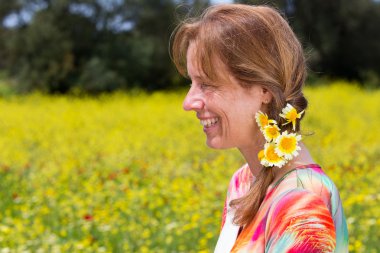 european woman wearing braid with yellow flowers near coleseed f