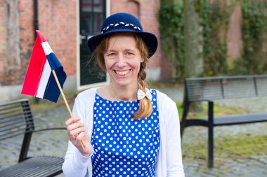European woman celebrating liberation with dutch flag