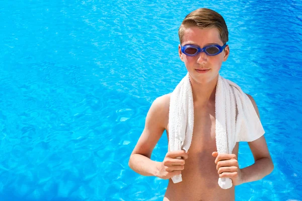 Dutch teenage boy wearing swimming goggles and towel at swimming — Stock Photo, Image