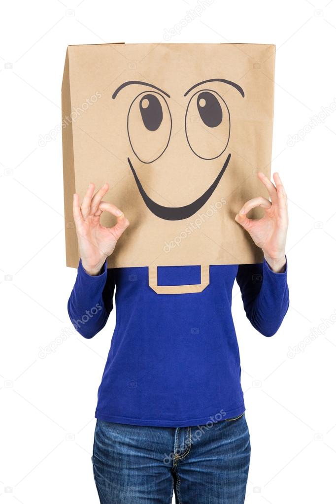 Happy smiling woman with paper bag on head