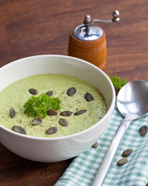 Homemade green broccoli cream soup served in white bowl — Stock Photo, Image