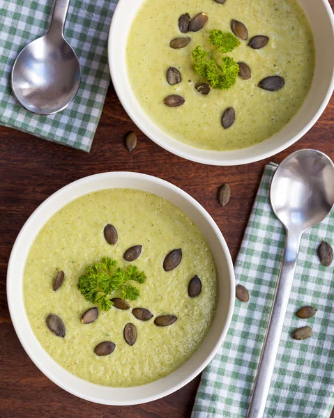 Homemade green broccoli cream soup served in white bowl — Stock Photo, Image