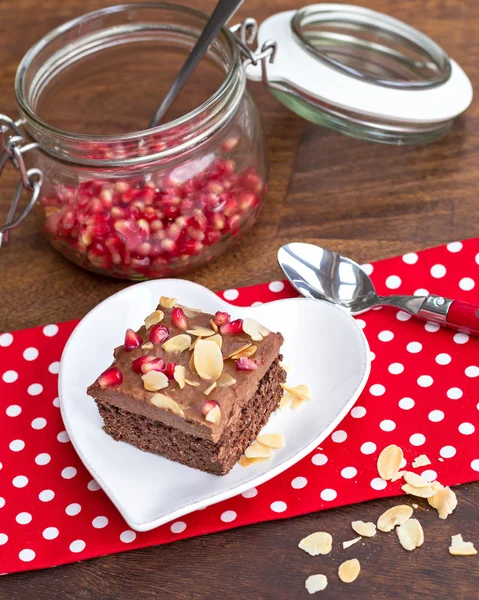 Chocolate cake decorated with pomegranate and almond — Stock Photo, Image