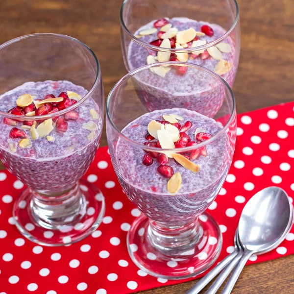 Purple chia pudding topped with pomegranate and almond — Stock Photo, Image