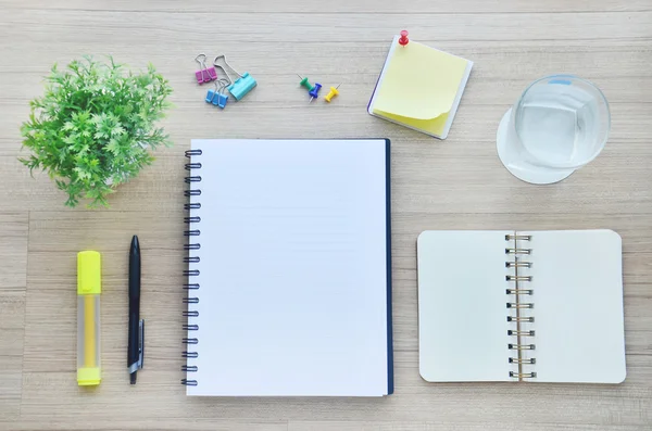 Blank paper and office tools on the wood table - Top view