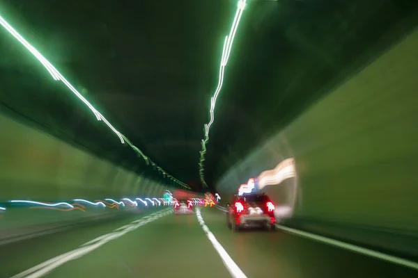 Cars inside the highway tunnel. Light trails effect.