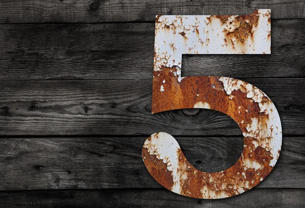 Old rusty metal alphabet, text 5 on Wooden Background — Stock Photo, Image