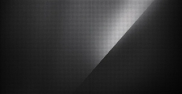 Spot lit perforated metal plate. Metal background close-up