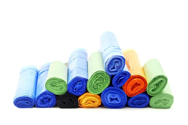 A lot of garbage bags rolls on a white background — Stock Photo, Image