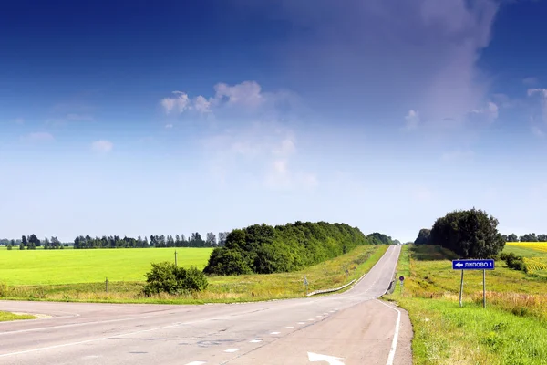 Russian road landscape. On the road sign specified distance to the village "Lipovo" Stock Photo