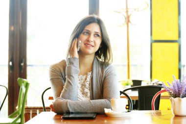 Cep telefonu için konuşurken Cafe kız